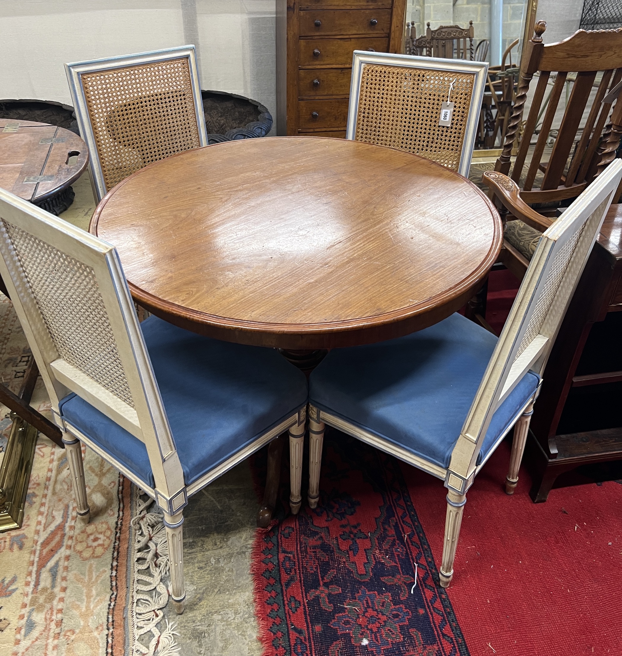 A set of four French style painted caned back dining chairs